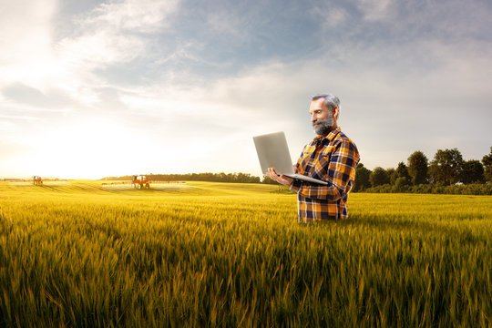 Beautiful senior farmer use new technology for agronomy