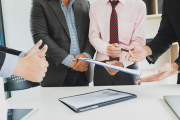 Businessman offering contract paper to his business partner for sign contract.