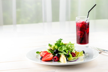 Fresh Blueberries, Cranberry salad with arugula, nuts, feta cheese, olive oil, herbs. Morning, breakfast healthy food.