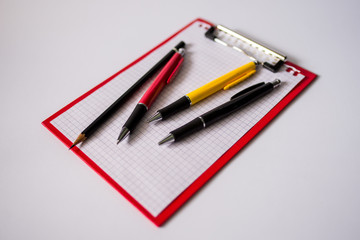 notebook and pencil on white background