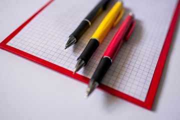 pencils and notebook on white background