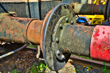 The rusty buffers of two old railway cars collide, transport