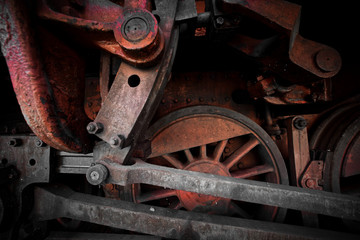 Close-up of the drive wheels and the drive rod of a historic steam locomotive