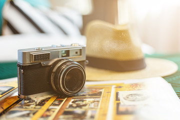 Camera and money sit atop a table, surrounded by vintage photography gear
