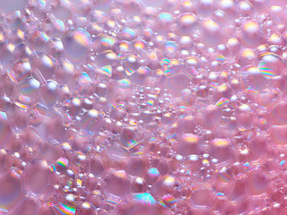 Iridescent bubbles on pink surface