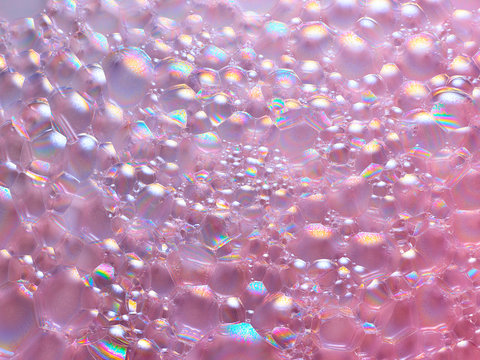 Iridescent bubbles on pink surface