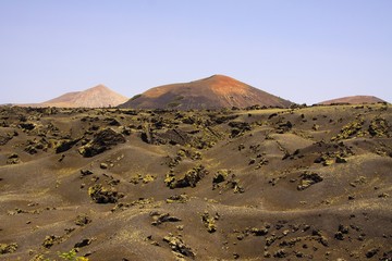 View over black lava field on cone of volcano - Timanfaya NP Lanzarote
