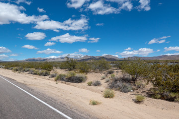 Fototapeta na wymiar Road in the Desert with mountains in the background, California