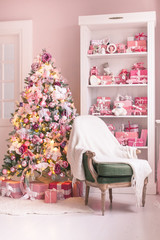 Cozy bright children's room with Christmas tree, chair and toys. Selective focus.
