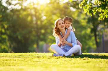 happy family mother and child daughter in nature   in summer
