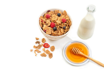 Healthy breakfast with bowl of cereal, orange juice, milk, , and fruits on white background.