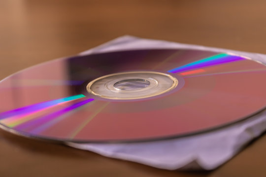 CD DVD disc on white paper cover box closeup - Image