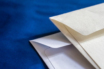 Two white paper envelopes on the dark blue background - Image