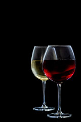 two glasses of red an withe Wine on black backgroundcopy space