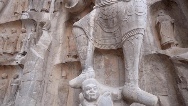 Giant statue of a Heavenly King at Fengxian Temple of Longmen Grotto  (Dragon's Gate Grottoes in chinese) in Luoyang, Henan Province, China