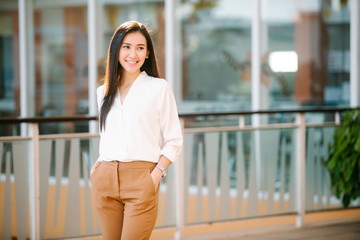 portrait of beautiful woman business executive style in downtown urban area