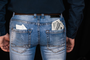condoms and banknotes money in back pockets men's jeans
