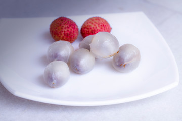 Advertising with lychee. Tropical fruit. Organic nutrition. Fresh fruit. Healthy drink. Sweet dessert. Healthy vegetarian food. Juice background. Summer, sweet food. Healthy diet. Vegetarian nutrition