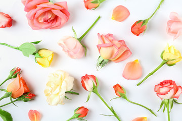 Feminine frame background made of various flowers with a lot of copy space for text. Close up, top view, flat lay.