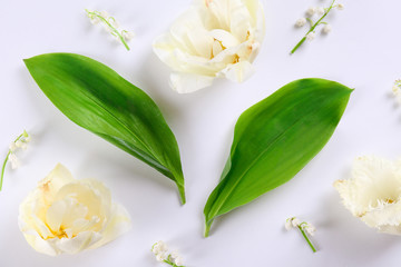 Feminine frame background made of various flowers with a lot of copy space for text. Close up, top view, flat lay.