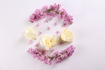 Feminine frame background made of various flowers with a lot of copy space for text. Close up, top view, flat lay.