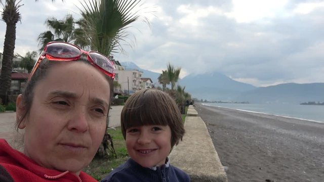 4K Child butts his head against his mothers forehead very painfully