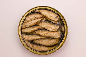 Open canned box with sprats from top on white background