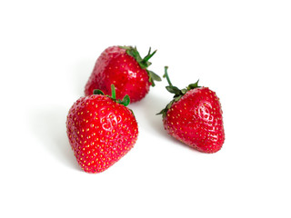 Three ripe red strawberries isolated on white background
