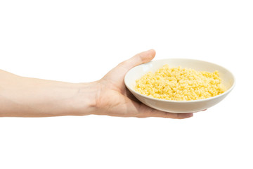 A plate of boiled Israeli couscous in men's hand isolated on a white background