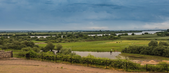 Fototapeta na wymiar meadows and floodplain before a thunderstorm