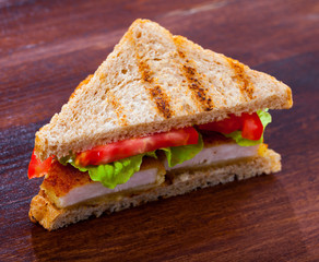 Tasty sandwich with  fried chicken nuggets, tomatoes and lettuce
