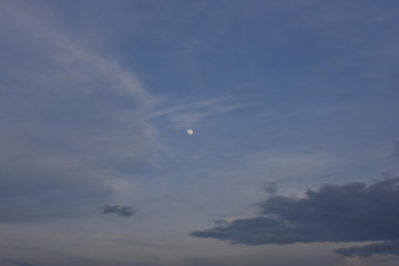 blue sky with clouds and the moon