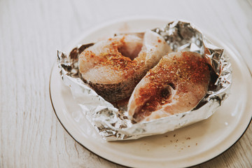 steaks of white fish with various herbs
