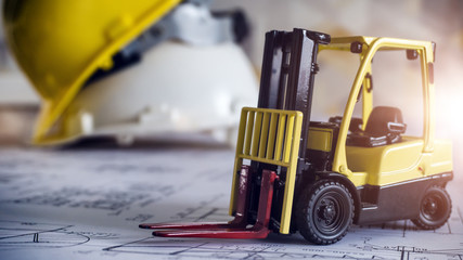 Logistic forklift stock photo with safety equipment yellow and white hard hat on background
