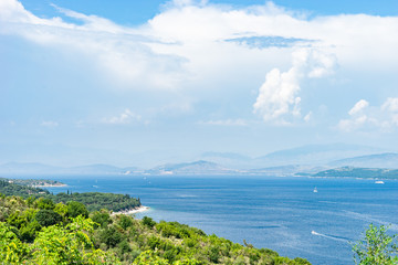 Fototapeta na wymiar View from Kerkira Corfu island to the Albanian coast over the sea at the Kassopei from the road