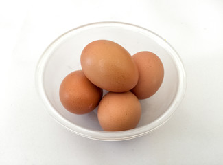 Eggs: brown eggs in separate cups on a white background in close-up shot from top to bottom Thailand