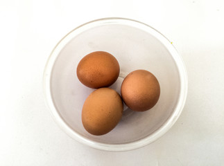 Eggs: brown eggs in separate cups on a white background in close-up shot from top to bottom Thailand
