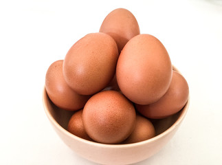 Eggs: brown eggs in separate cups on a white background in close-up shot from top to bottom Thailand