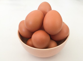 Eggs: brown eggs in separate cups on a white background in close-up shot from top to bottom Thailand