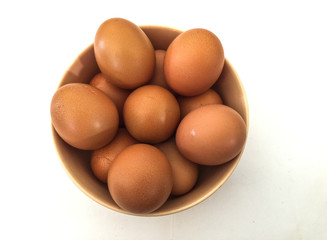 Eggs: brown eggs in separate cups on a white background in close-up shot from top to bottom Thailand