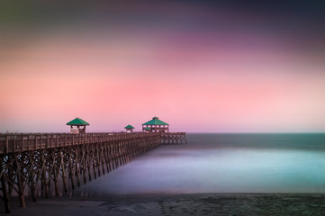 Long exposure of Folly Beach pier in South Carolina. The exposure creates a blur in the clouds and water.