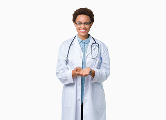 Fototapeta premium Young african american doctor woman wearing medical coat over isolated background Smiling with hands palms together receiving or giving gesture. Hold and protection