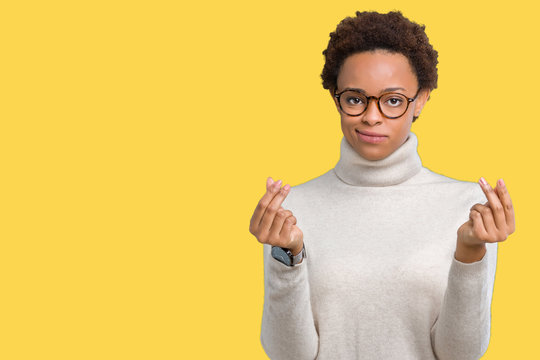 Young beautiful african american woman wearing glasses over isolated background Doing money gesture with hand, asking for salary payment, millionaire business