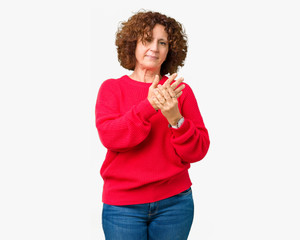 Beautiful middle ager senior woman red winter sweater over isolated background Suffering pain on...