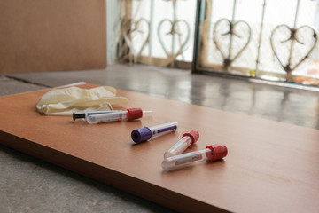 Plain Clot bloot Activators and syringe's on wooden textured table in Laboratory