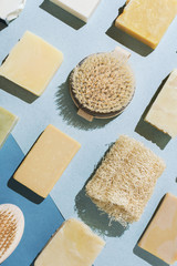 Flatlay of various natural handmade soap, body brushes and loofah sponge, sustainable beauty...