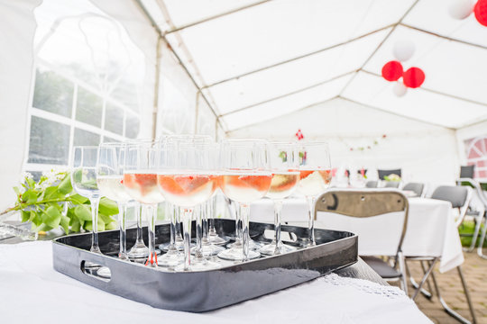 Drinks on a table in a bright tent at a party