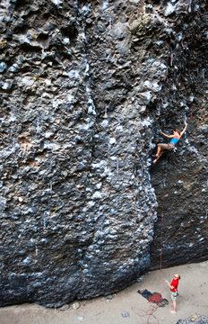 Climbers at the crux on the Roache (5.11a) at Deep Creek.