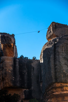 A slackliner hangs after a failed attempt to cross near margalef, Spain.