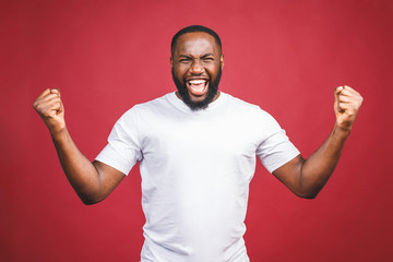 I'm winner. Portrait of happy african american man isolated over red background.